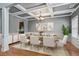 Stately dining room with coffered ceilings and a dining table set for eight at 4745 Prather Farm Cir, Cumming, GA 30040