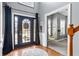 Elegant foyer with hardwood floors, a decorative front door, and a view of a cozy hammock room at 4745 Prather Farm Cir, Cumming, GA 30040