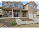 Charming front entrance with a covered porch, decorative columns, and beautiful landscaping at 4745 Prather Farm Cir, Cumming, GA 30040