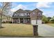 Stunning two-story brick home with a well-manicured lawn, covered porch, and two-car garage at 4745 Prather Farm Cir, Cumming, GA 30040