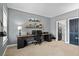 Well-lit home office featuring a large desk, shelving, and neutral decor at 4745 Prather Farm Cir, Cumming, GA 30040