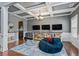 Entertainment space with coffered ceilings, hardwood floors, and three mounted TV screens at 4745 Prather Farm Cir, Cumming, GA 30040