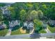 An aerial view showcases a house with a well-manicured lawn and mature trees providing shade and privacy at 3027 Clove Tree Ln, Woodstock, GA 30189