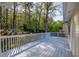 Large back deck features white railing with a view of the backyard and trees at 3027 Clove Tree Ln, Woodstock, GA 30189