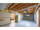 Unfinished basement features exposed wood ceiling, concrete walls, and painted floor at 3027 Clove Tree Ln, Woodstock, GA 30189