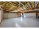 Spacious unfinished basement with exposed ceiling, concrete walls, and garage access at 3027 Clove Tree Ln, Woodstock, GA 30189