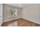 Another bedroom with hardwood floors and a window providing ample light at 3027 Clove Tree Ln, Woodstock, GA 30189