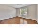 A secondary bedroom with hardwood floors and a window with blinds at 3027 Clove Tree Ln, Woodstock, GA 30189