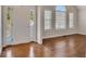 Bright entryway featuring hardwood floors, sidelight window, and arched window at 3027 Clove Tree Ln, Woodstock, GA 30189