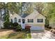 Charming home with a manicured lawn, complemented by beautiful landscaping and a welcoming front porch at 3027 Clove Tree Ln, Woodstock, GA 30189