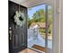 Inviting front door with wreath, sidelight window, and welcome mat at 3027 Clove Tree Ln, Woodstock, GA 30189