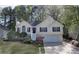 Charming home with landscaped front yard, attached garage, and stairway entry at 3027 Clove Tree Ln, Woodstock, GA 30189