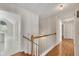 Upstairs hallway featuring hardwood floors, multiple closets, and leads to other rooms at 3027 Clove Tree Ln, Woodstock, GA 30189
