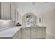 Bright kitchen featuring white counters and cabinets, with a window over the sink at 3027 Clove Tree Ln, Woodstock, GA 30189