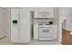 Clean kitchen features white appliances, cabinets, and a white tile floor at 3027 Clove Tree Ln, Woodstock, GA 30189