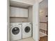 The laundry room features a washer, dryer, and plenty of storage cabinets at 3027 Clove Tree Ln, Woodstock, GA 30189