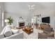 Spacious living room with fireplace and adjacent dining area, perfect for entertaining guests and Gathering at 3027 Clove Tree Ln, Woodstock, GA 30189