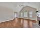 Cozy living room with hardwood floors, a fireplace, and large windows offering plenty of natural light at 3027 Clove Tree Ln, Woodstock, GA 30189