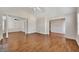 Expansive living area featuring hardwood floors, columns, and access to the dining area at 3027 Clove Tree Ln, Woodstock, GA 30189