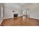 Open-concept living room with hardwood floors, vaulted ceilings, and a cozy fireplace focal point at 3027 Clove Tree Ln, Woodstock, GA 30189