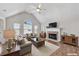 Inviting living room features vaulted ceilings, a cozy fireplace, and ample natural light from large windows at 3027 Clove Tree Ln, Woodstock, GA 30189