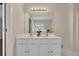 Main bathroom showing a double sink vanity with large framed mirror at 3027 Clove Tree Ln, Woodstock, GA 30189