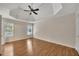 Spacious main bedroom featuring hardwood floors and trey ceilings with fan at 3027 Clove Tree Ln, Woodstock, GA 30189