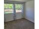 Bedroom with carpet and a view of the landscaped backyard through a window at 3785 Somerset Sw Dr, Marietta, GA 30064