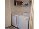 Bright laundry room featuring new washer and dryer, and storage shelves at 3785 Somerset Sw Dr, Marietta, GA 30064