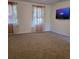 Spacious living room with plush carpeting, large windows, and a modern entertainment center at 3785 Somerset Sw Dr, Marietta, GA 30064