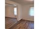 Bright living room featuring durable wood flooring and large windows at 3785 Somerset Sw Dr, Marietta, GA 30064