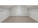 Unfinished attic space with storage shelves, offering potential for customization at 423 Morgan Falls Chase, Canton, GA 30114