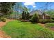 Expansive backyard featuring well-maintained landscaping, lush green grass, and mature trees at 423 Morgan Falls Chase, Canton, GA 30114