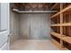 Unfinished basement area with wooden shelving, ideal for storage or workshop space at 423 Morgan Falls Chase, Canton, GA 30114