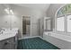 Bright bathroom boasts double sinks, walk-in shower, garden tub, arched window and walk-in closet at 423 Morgan Falls Chase, Canton, GA 30114