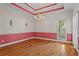 Elegant dining room with hardwood floors, decorative trim, and a stylish chandelier at 423 Morgan Falls Chase, Canton, GA 30114