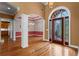Grand foyer featuring hardwood floors, elegant columns, and a decorative front door at 423 Morgan Falls Chase, Canton, GA 30114