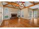 Spacious living room with hardwood floors, fireplace, and vaulted ceiling with exposed beams at 423 Morgan Falls Chase, Canton, GA 30114