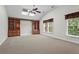 Spacious living room with built-in shelves, skylights, ceiling fan, and a view of the backyard at 423 Morgan Falls Chase, Canton, GA 30114