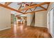 Open-concept living room showcasing hardwood floors, staircase, and view into the kitchen at 423 Morgan Falls Chase, Canton, GA 30114