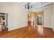 Open-concept living area showcasing hardwood floors, elegant archways, and a view of the foyer at 423 Morgan Falls Chase, Canton, GA 30114