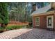 Beautiful brick patio, surrounded by greenery, creates a tranquil outdoor living space at 423 Morgan Falls Chase, Canton, GA 30114