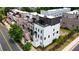 Aerial view highlights townhomes with rooftop decks, landscaping, and street parking at 4812 Moonview Ln # 4, Sugar Hill, GA 30518