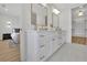 Bright bathroom with double vanity, gold fixtures, and a bedroom view at 4812 Moonview Ln # 4, Sugar Hill, GA 30518