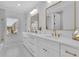 Bright bathroom features double sinks, modern fixtures, and a large window providing natural light and an outdoor view at 4812 Moonview Ln # 4, Sugar Hill, GA 30518