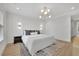 Bright bedroom featuring a stylish bed, modern lighting fixtures, and decorative wall panels and trim at 4812 Moonview Ln # 4, Sugar Hill, GA 30518