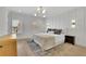 Bright bedroom featuring a stylish bed, modern lighting fixtures, and windows providing natural light and a street view at 4812 Moonview Ln # 4, Sugar Hill, GA 30518