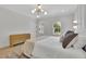 Bright bedroom featuring a stylish bed, modern lighting fixtures, and windows providing natural light and a street view at 4812 Moonview Ln # 4, Sugar Hill, GA 30518