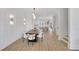 Spacious dining room showcasing modern lighting, wainscoting, and seamless flow to the kitchen at 4812 Moonview Ln # 4, Sugar Hill, GA 30518