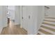 Bright hallway features a stairwell, elevator, and hardwood floors leading to another room with natural light at 4812 Moonview Ln # 4, Sugar Hill, GA 30518